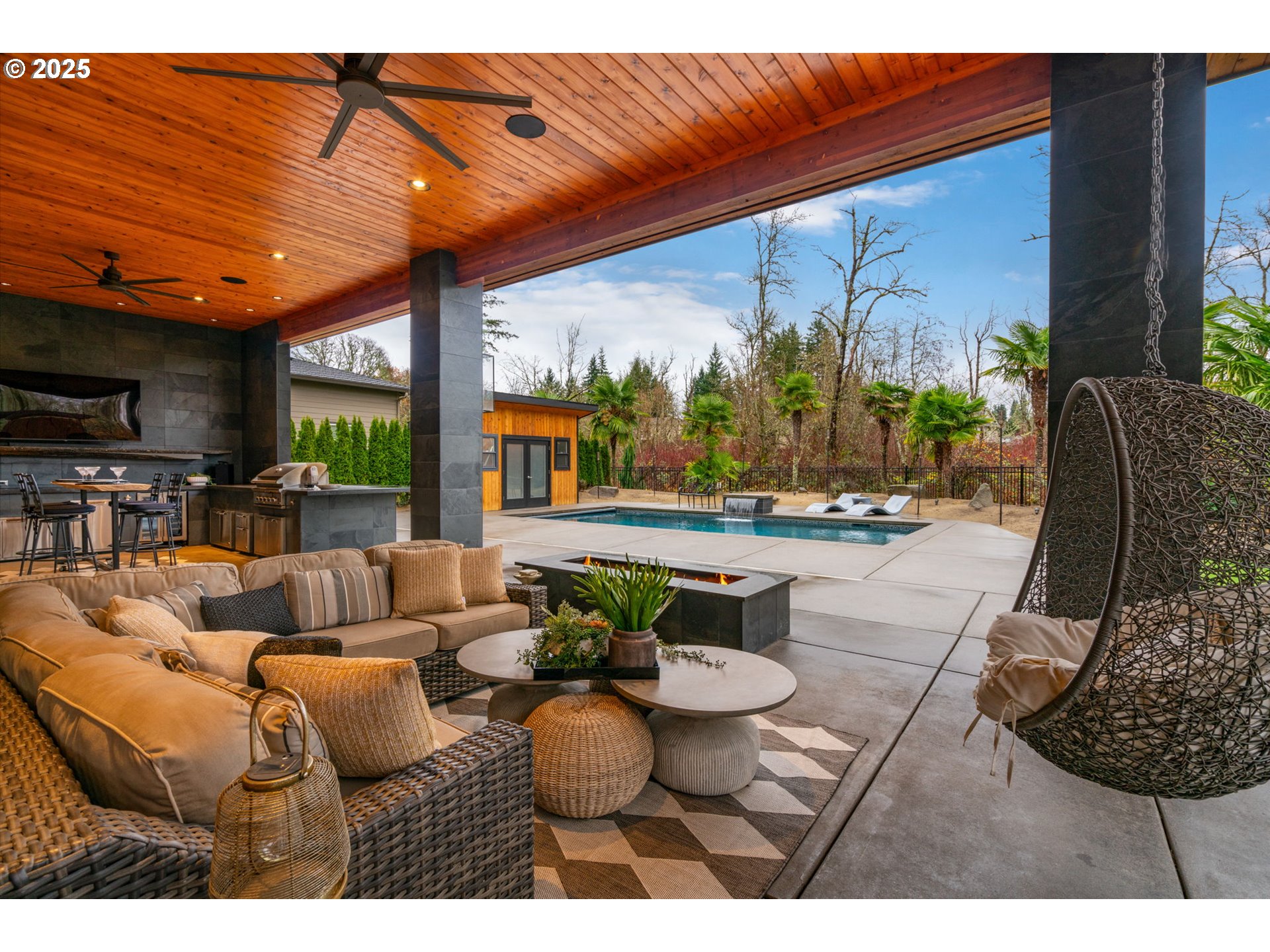 6730 Northwest Longbow Lane Camas, WA 98607 - Photo 5 of 45 a living room with furniture a flat screen tv and a floor to ceiling window