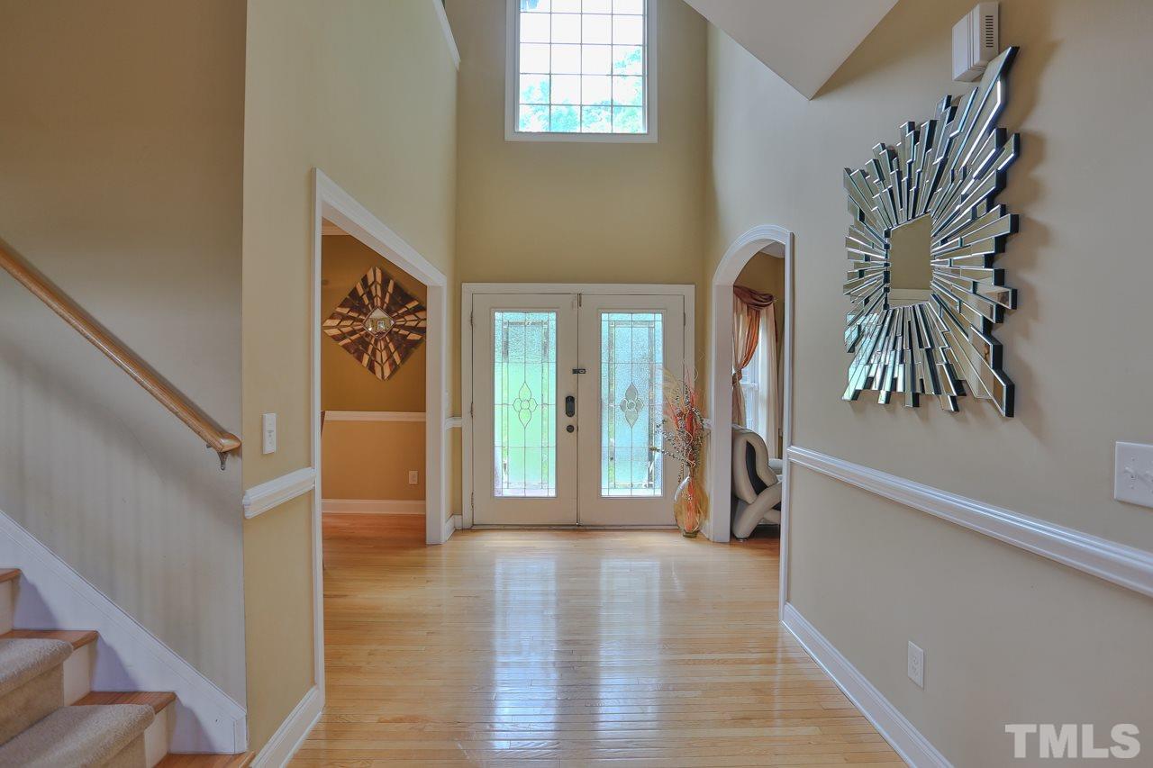 6448 Guess Road Durham, NC 27712 - Photo 2 of 23 a view of hallway with wooden floor and stairs
