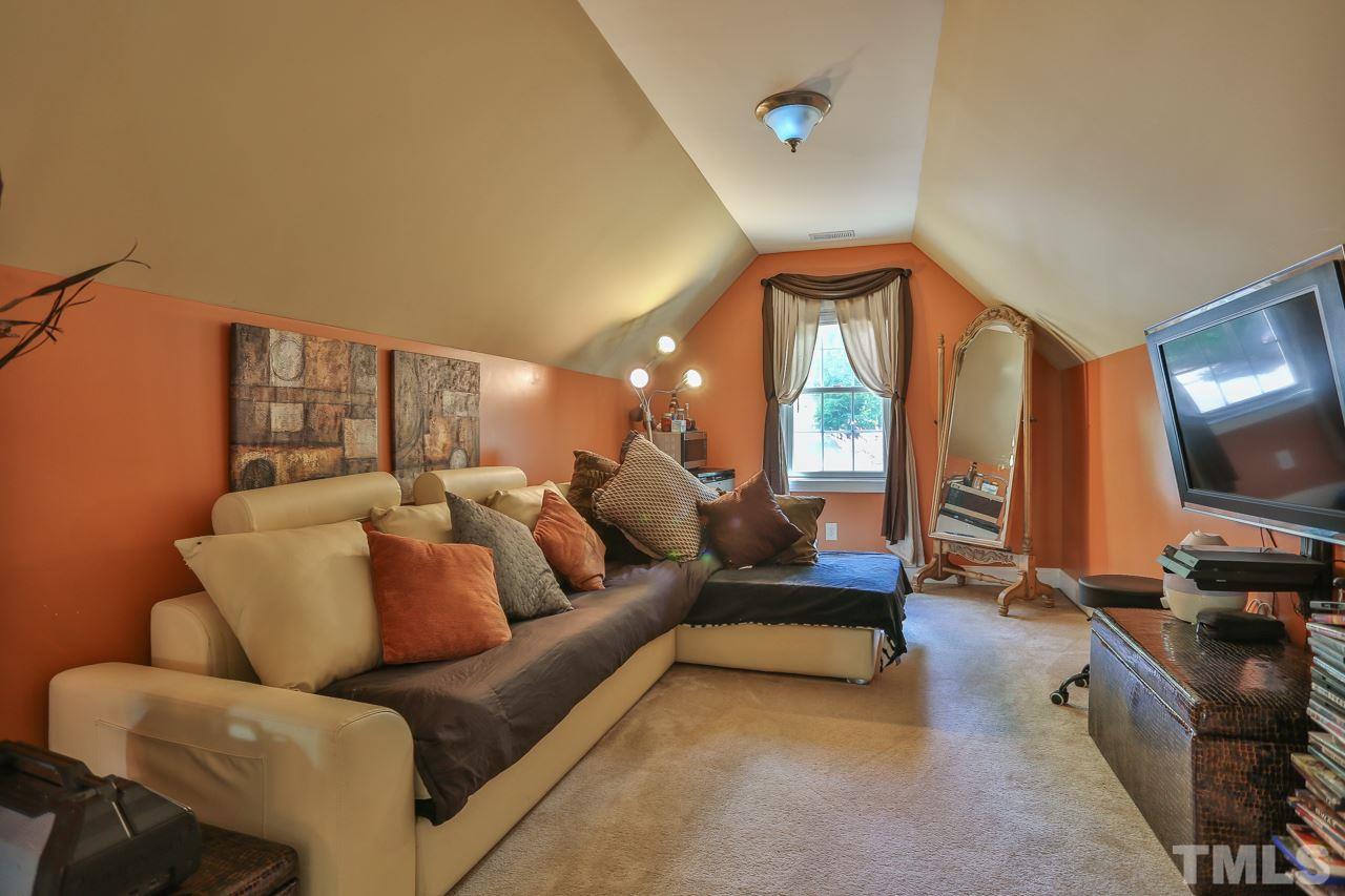 6448 Guess Road Durham, NC 27712 - Photo 14 of 23 a living room with furniture and a flat screen tv