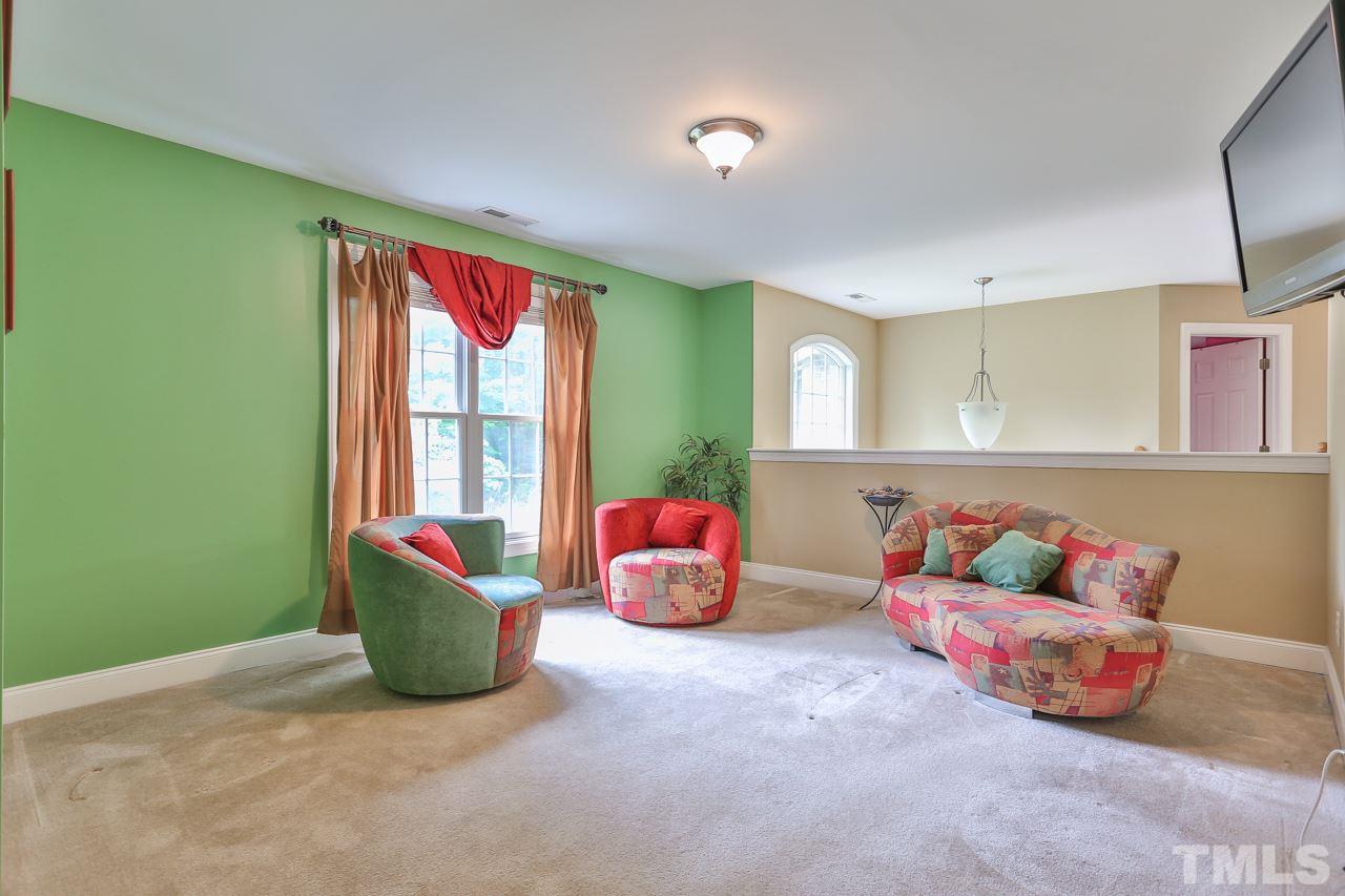 6448 Guess Road Durham, NC 27712 - Photo 17 of 23 a living room with furniture and a large window
