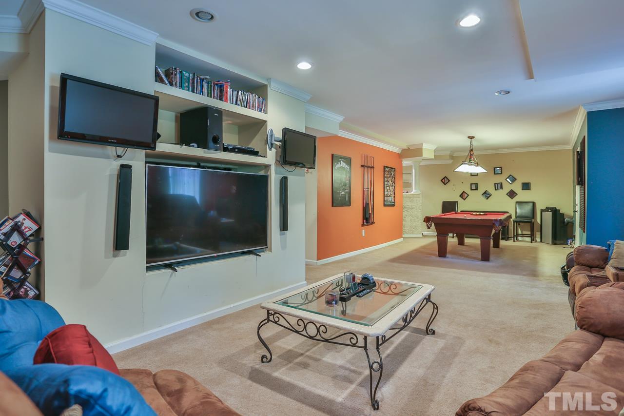 6448 Guess Road Durham, NC 27712 - Photo 20 of 23 a living room with furniture and a flat screen tv
