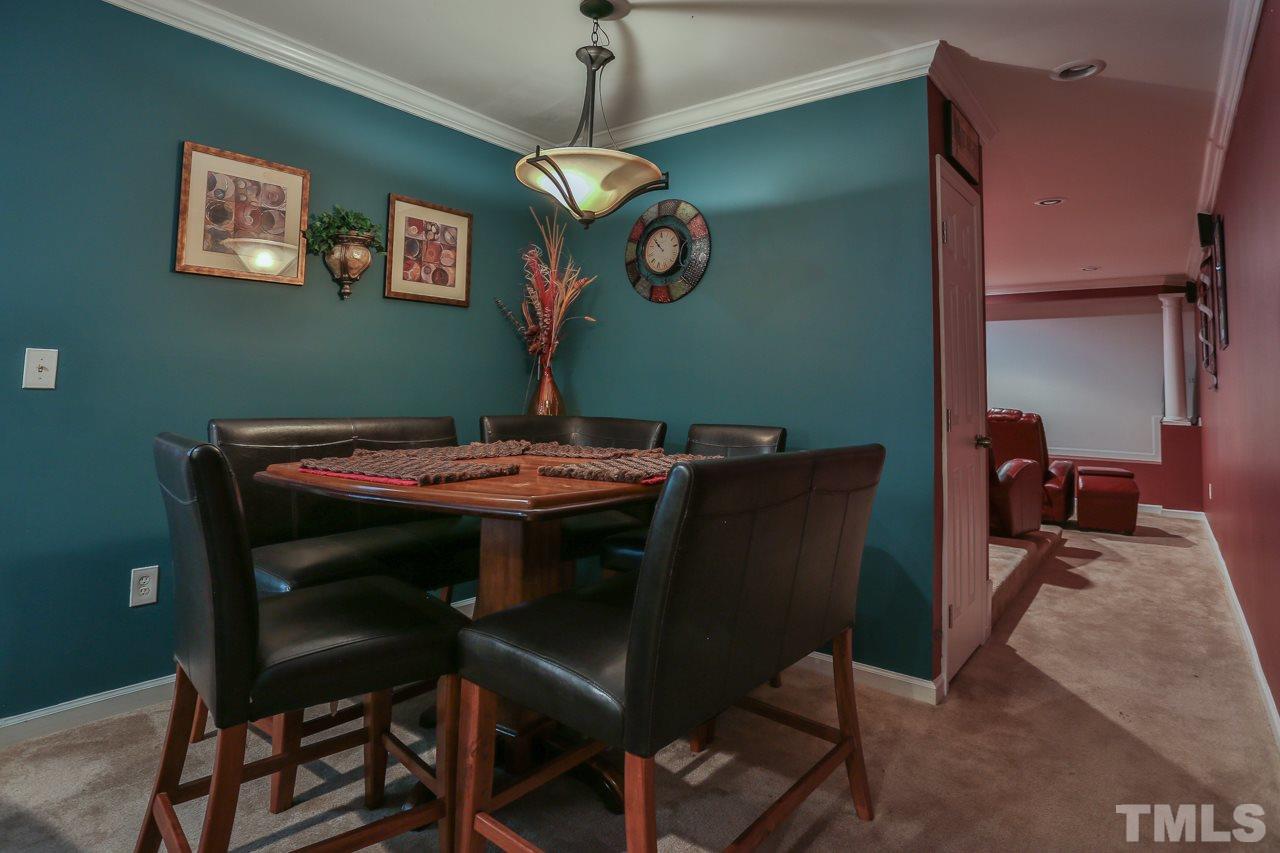 6448 Guess Road Durham, NC 27712 - Photo 21 of 23 a dining room with a table and chairs
