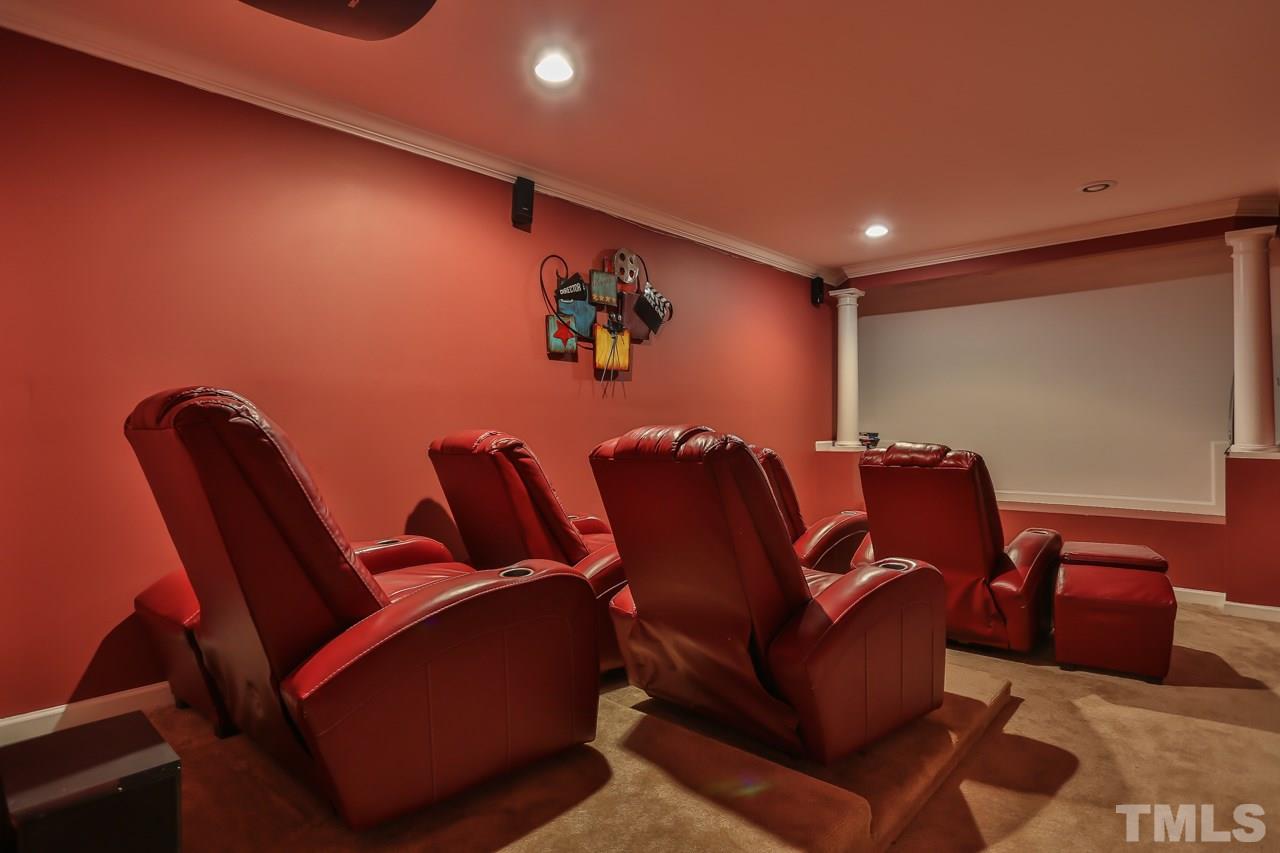 6448 Guess Road Durham, NC 27712 - Photo 22 of 23 a media room with lots of chairs and a projector screen