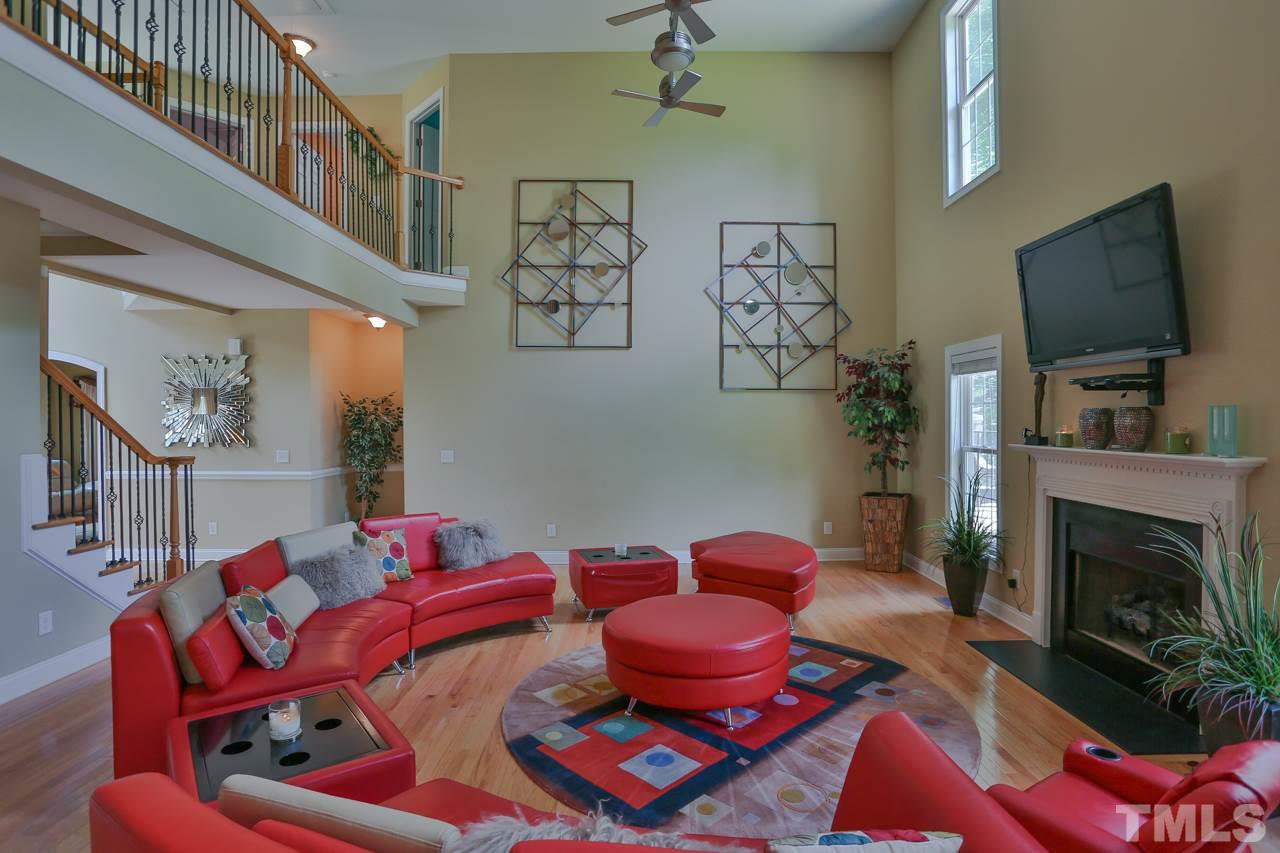 6448 Guess Road Durham, NC 27712 - Photo 5 of 23 a living room with furniture a flat screen tv and a fireplace