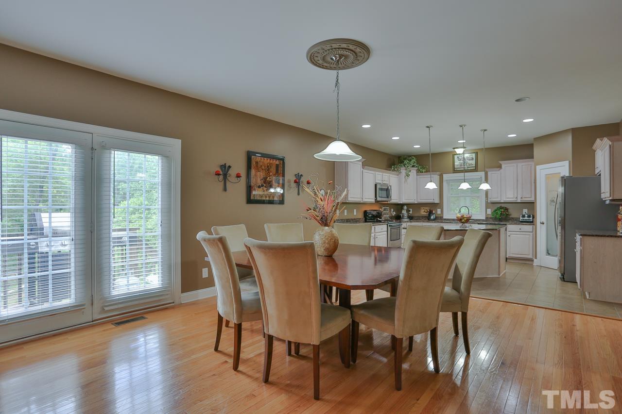 6448 Guess Road Durham, NC 27712 - Photo 6 of 23 a dining room with furniture window and wooden floor