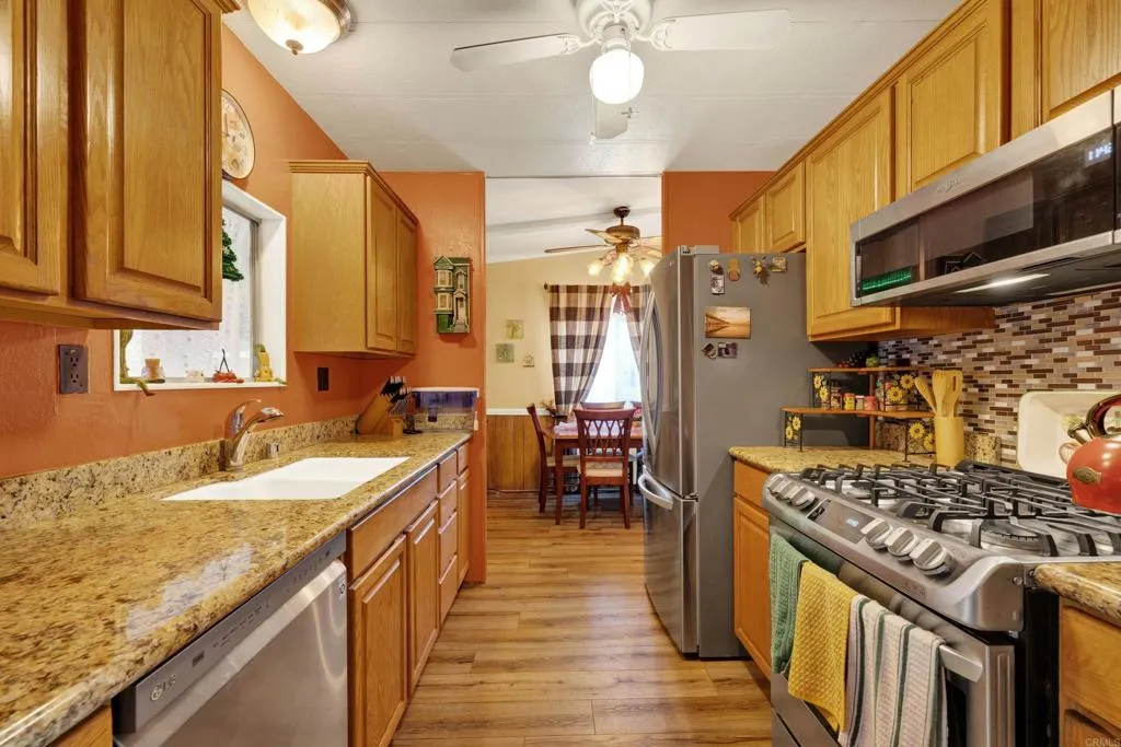 9459 Mission Gorge Road, Unit SPC 16 Santee, CA 92071 - Photo 1 of 1 a kitchen with stainless steel appliances granite countertop a sink stove and refrigerator