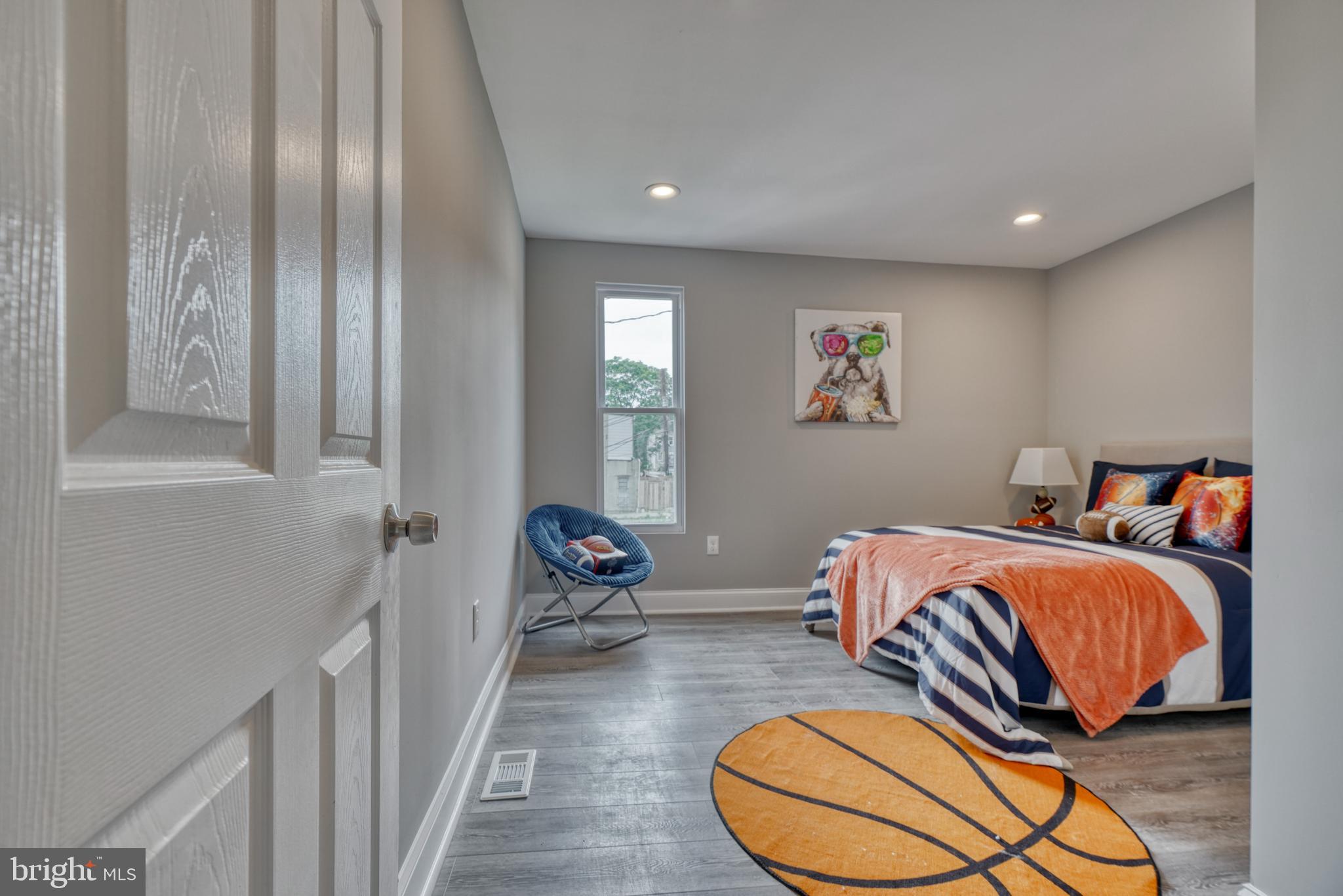 1506 North Wolfe Street Baltimore, MD 21213 - Photo 5 of 9 a bedroom with furniture and a large window