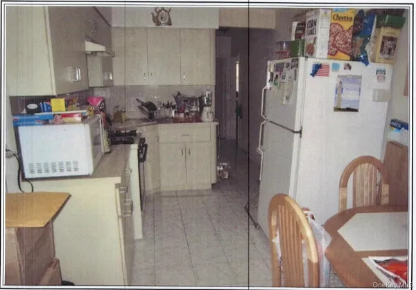 a kitchen with stainless steel appliances a refrigerator stove and microwave