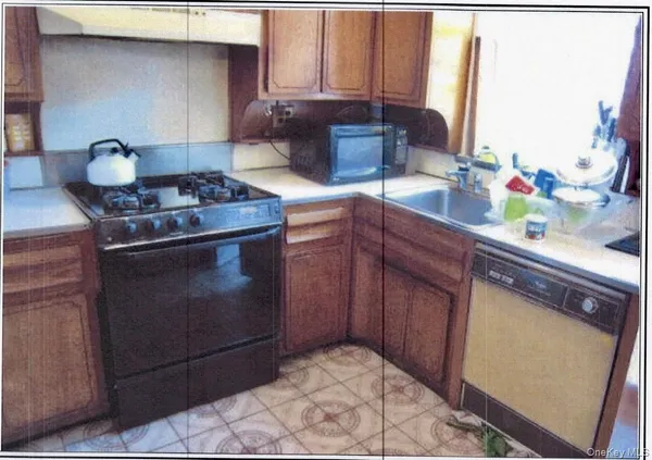 a kitchen with cabinets stainless steel appliances and wooden floor