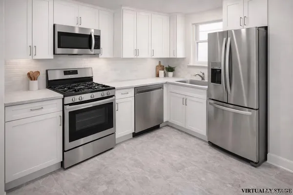 a kitchen with stainless steel appliances a refrigerator and a stove