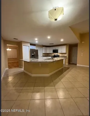 a kitchen with stainless steel appliances granite countertop a sink and cabinets