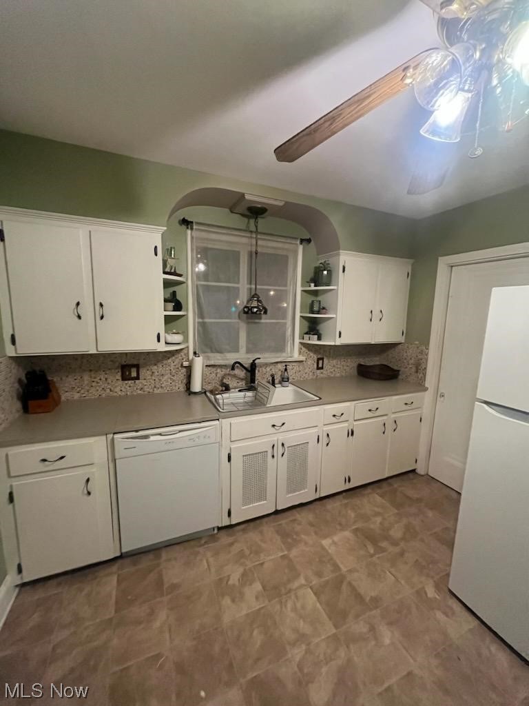 2444 Manchester Road Akron, OH 44314 - Photo 23 of 26 Kitchen with sink, white cabinets, white appliances, backsplash, and ceiling fan