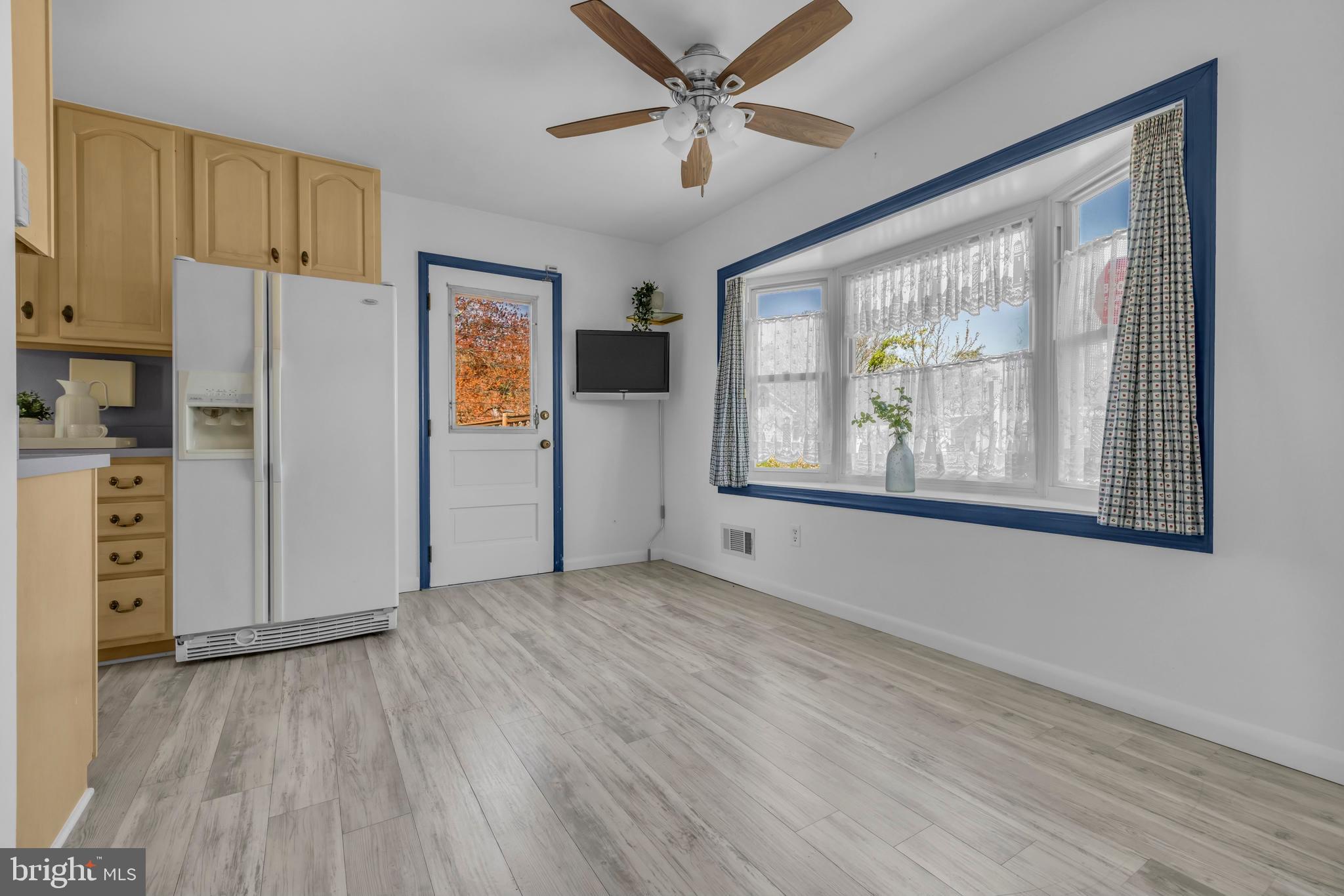 9807 Locust Avenue Lanham, MD 20706 - Photo 11 of 59 a view of an empty room with a window and wooden floor