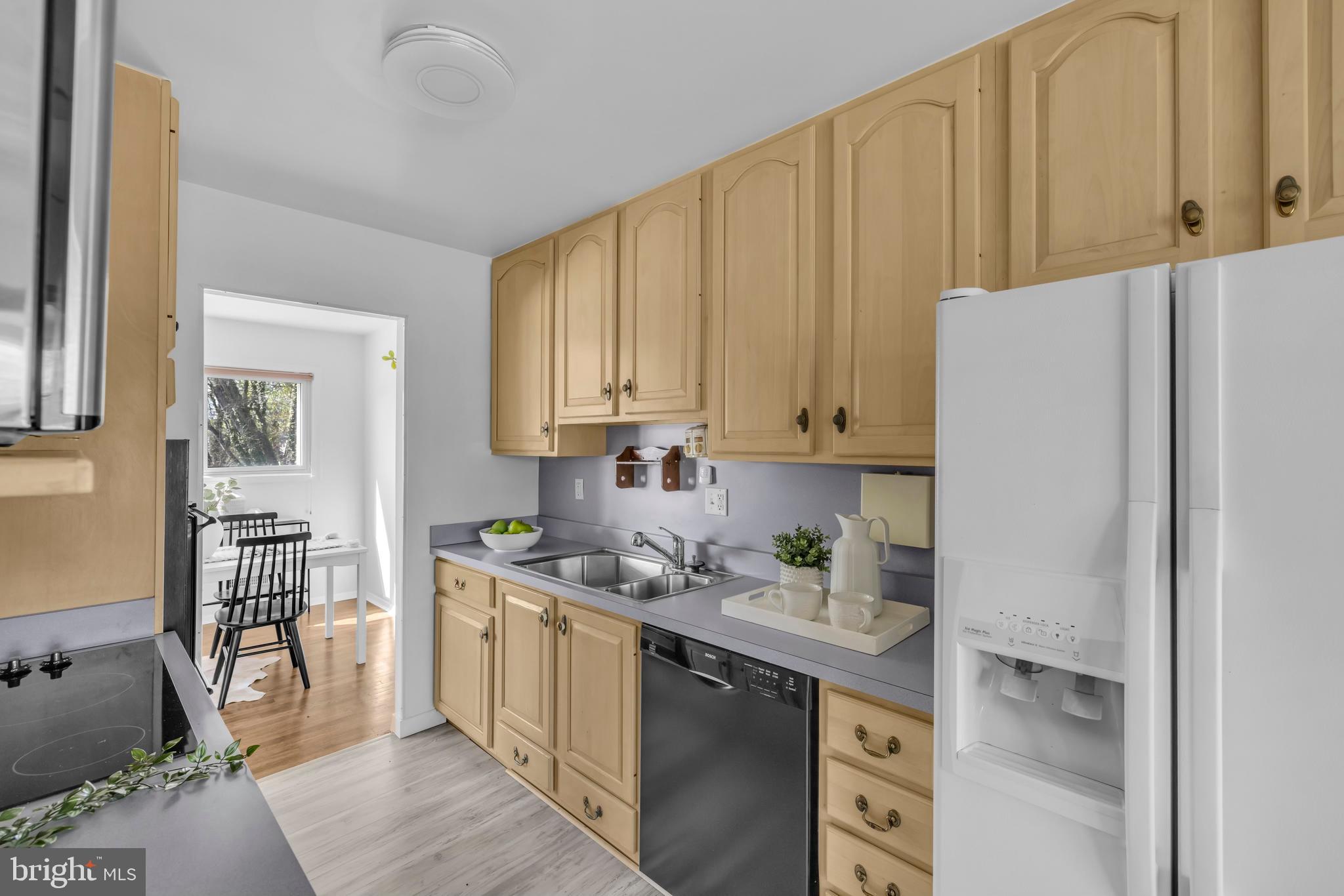 9807 Locust Avenue Lanham, MD 20706 - Photo 14 of 59 a kitchen with stainless steel appliances granite countertop a refrigerator sink and cabinets