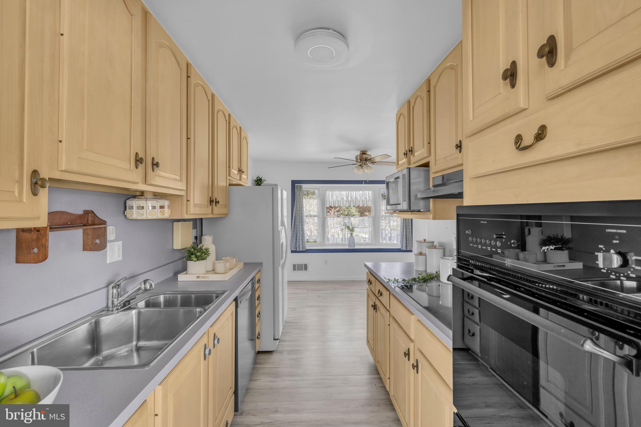 9807 Locust Avenue Lanham, MD 20706 - Photo 15 of 59 a kitchen with stainless steel appliances granite countertop a sink stove and refrigerator