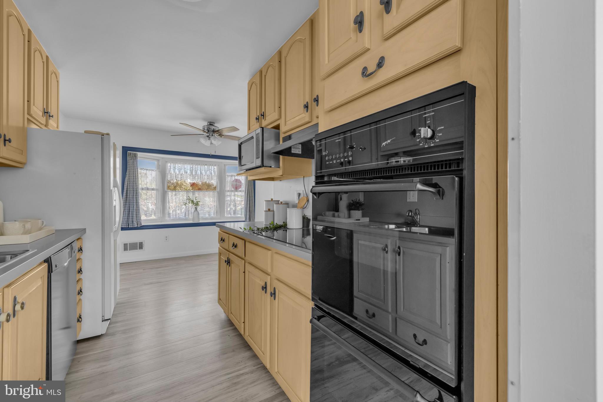 9807 Locust Avenue Lanham, MD 20706 - Photo 16 of 59 a kitchen with stainless steel appliances granite countertop a stove and a refrigerator