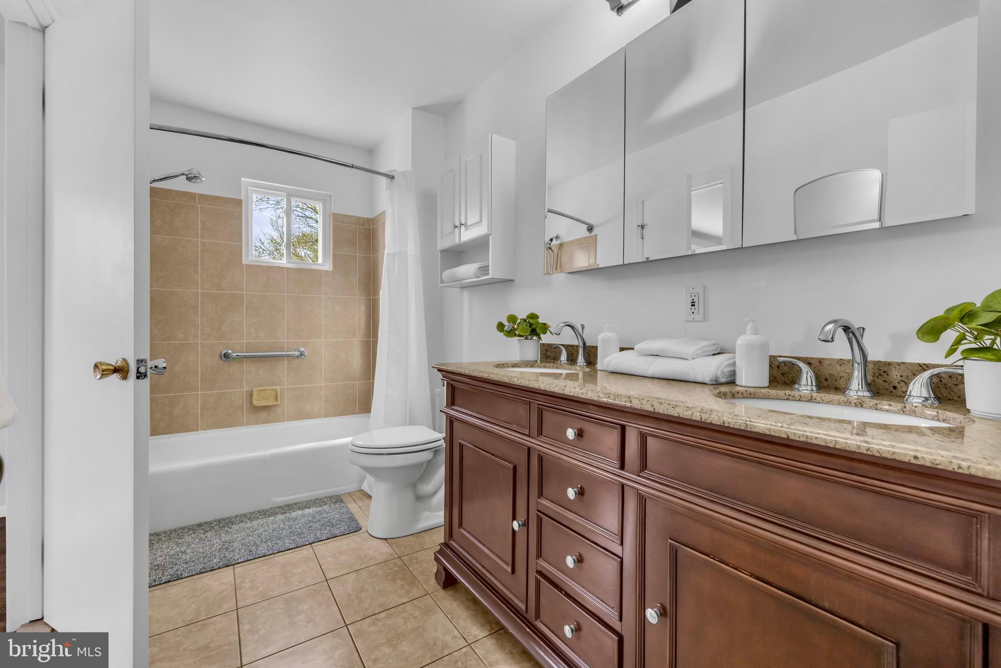 9807 Locust Avenue Lanham, MD 20706 - Photo 22 of 59 a bathroom with a sink a toilet and bathtub