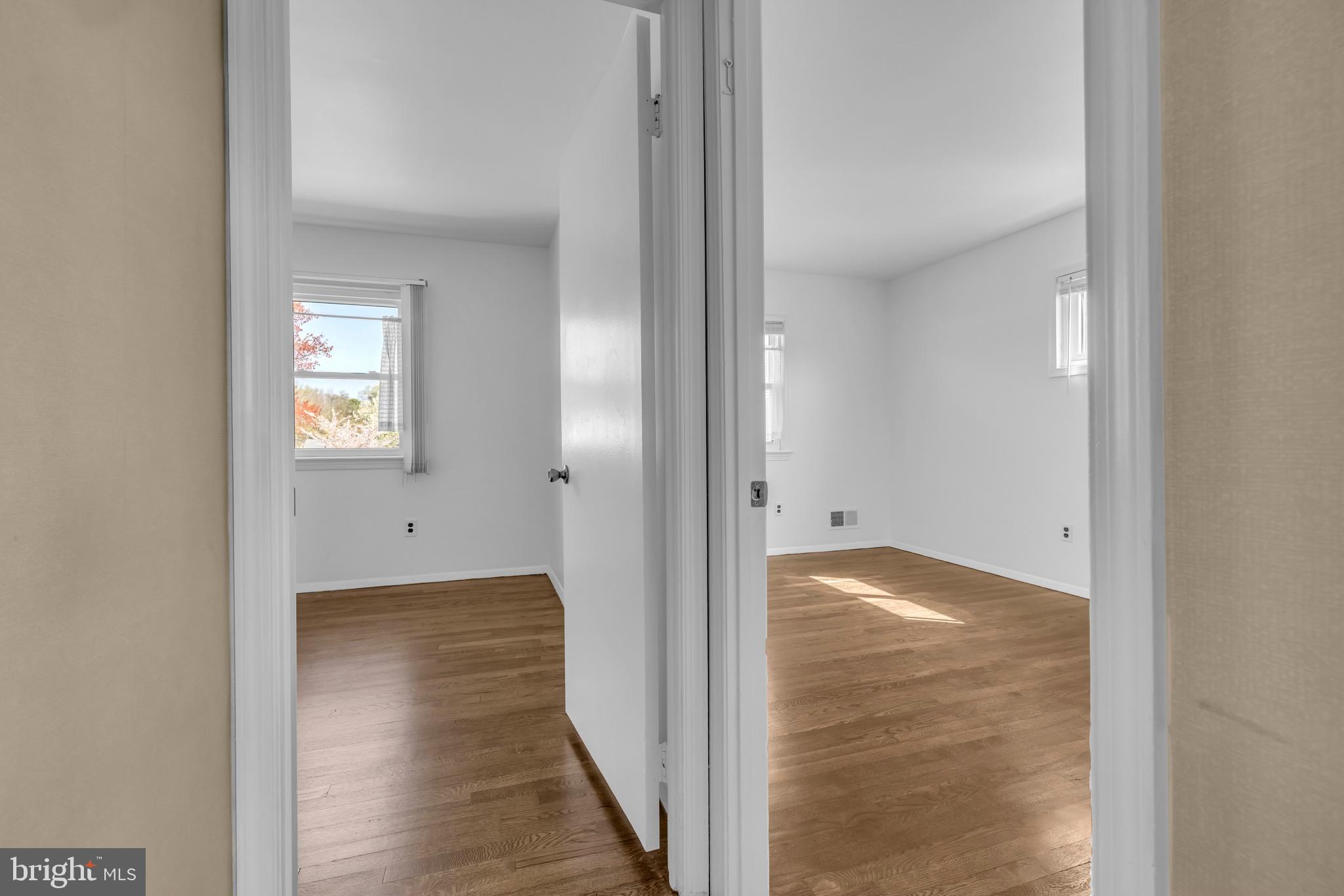 9807 Locust Avenue Lanham, MD 20706 - Photo 25 of 59 a view of an empty room with window and wooden floor