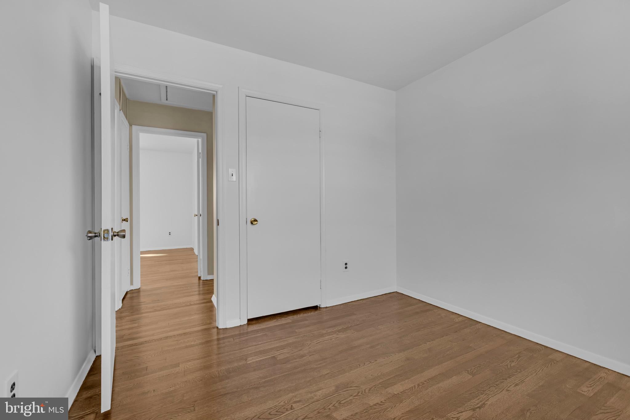 9807 Locust Avenue Lanham, MD 20706 - Photo 28 of 59 a view of an empty room with wooden floor