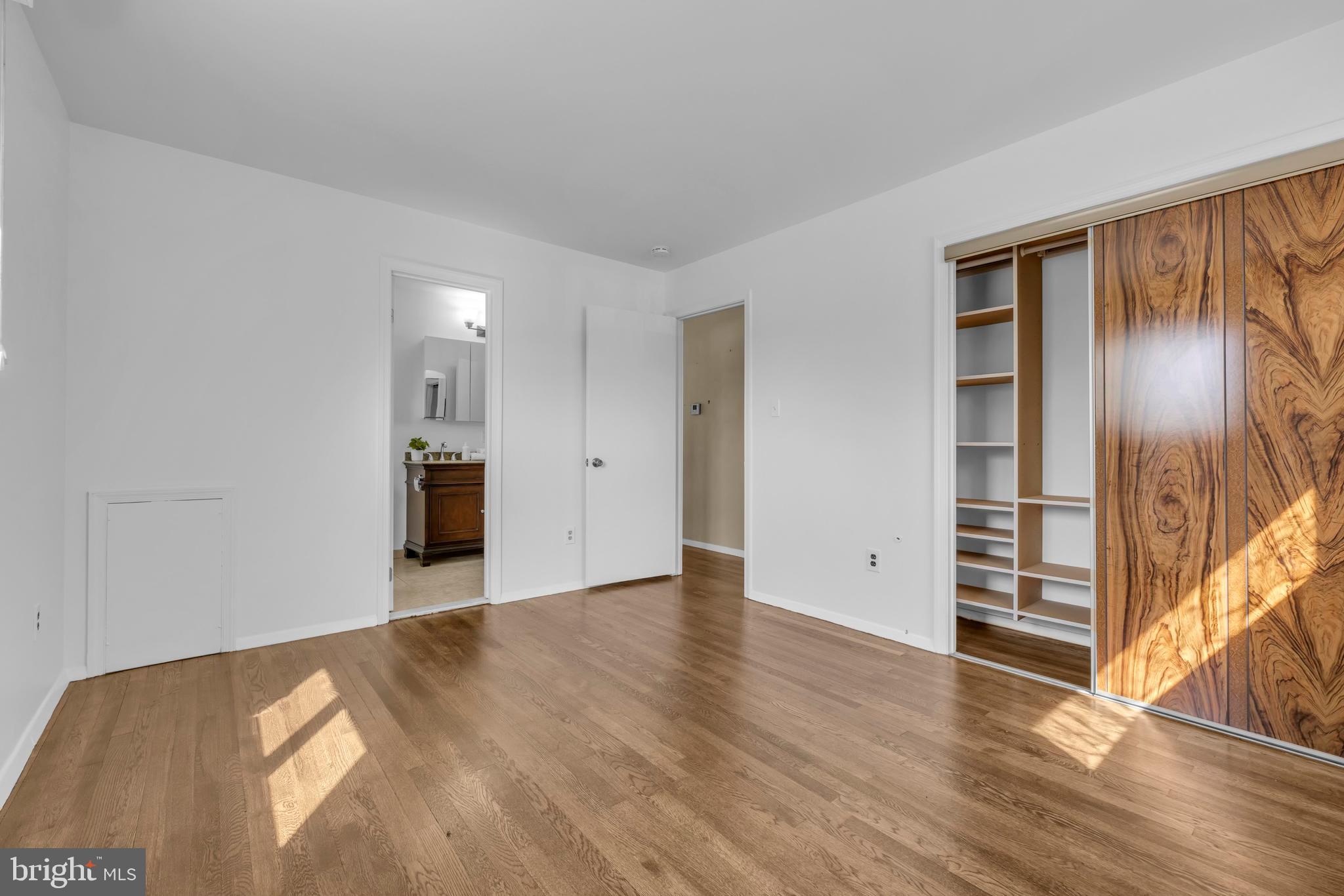 9807 Locust Avenue Lanham, MD 20706 - Photo 30 of 59 a view of an empty room with wooden floor and a window