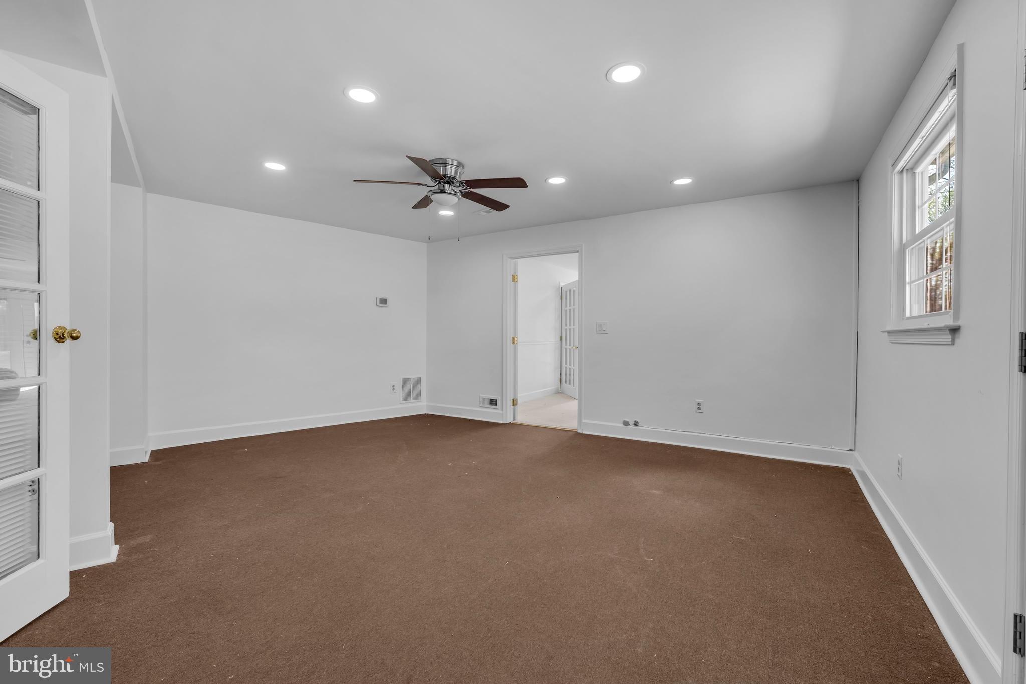 9807 Locust Avenue Lanham, MD 20706 - Photo 37 of 59 an empty room with a ceiling fan and window