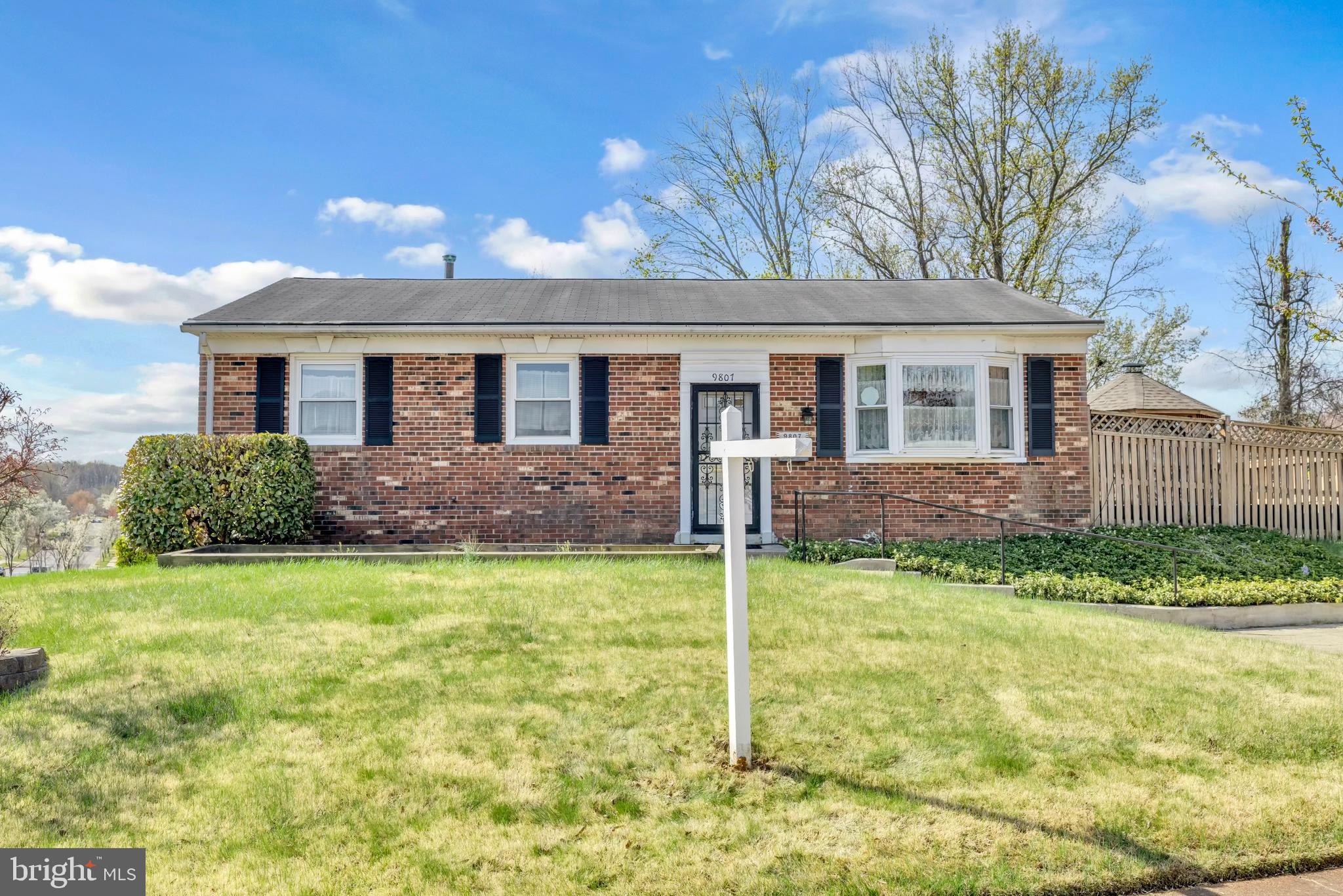 9807 Locust Avenue Lanham, MD 20706 - Photo 4 of 59 a front view of a house with a yard