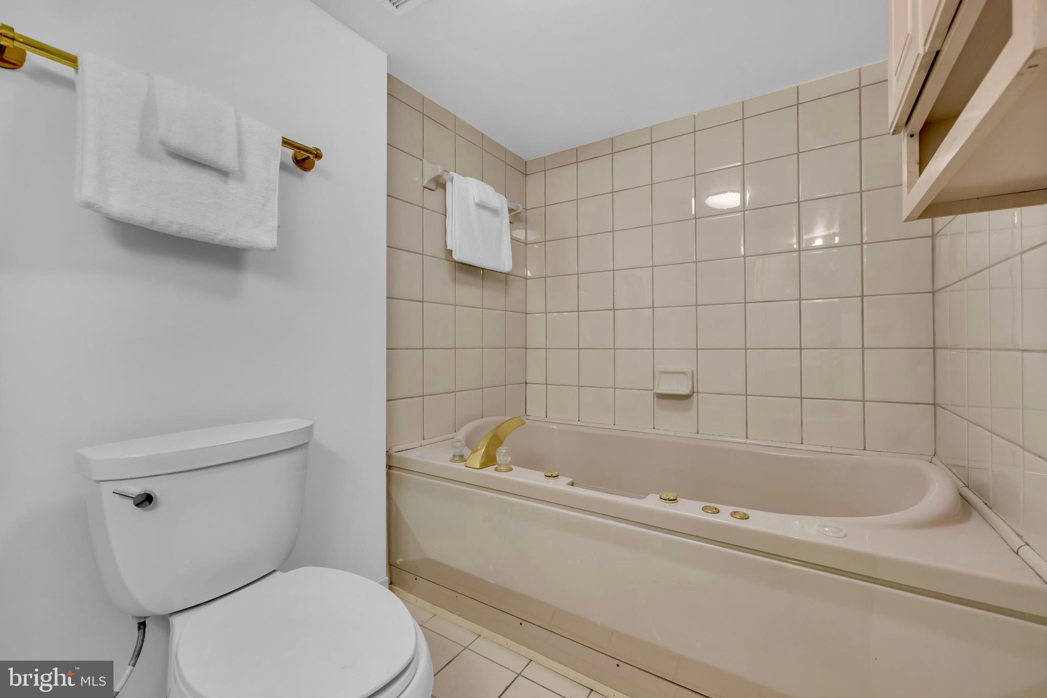 9807 Locust Avenue Lanham, MD 20706 - Photo 47 of 59 a white bath tub sitting next to a white toilet
