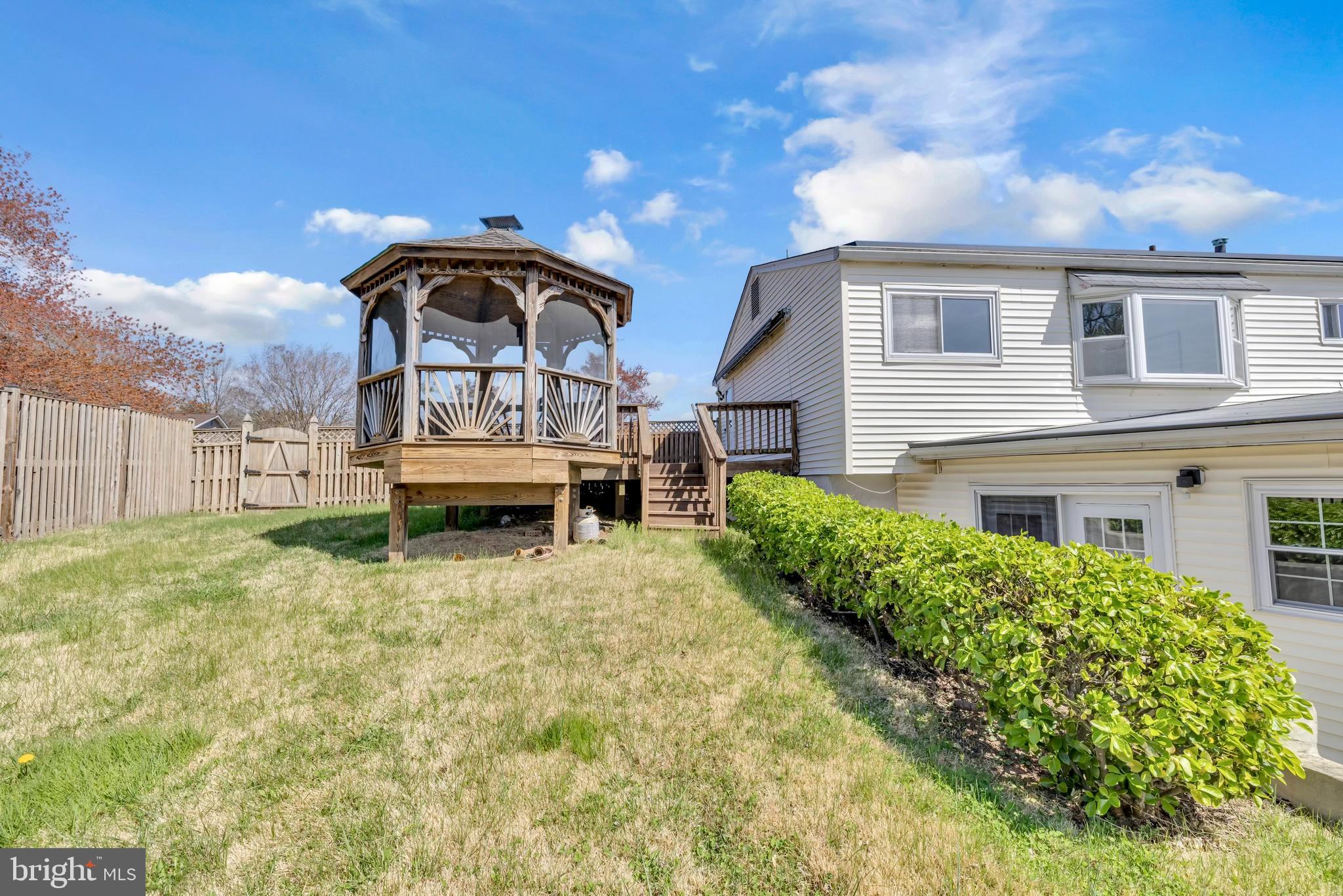 9807 Locust Avenue Lanham, MD 20706 - Photo 52 of 59 a view of a house with a yard and deck