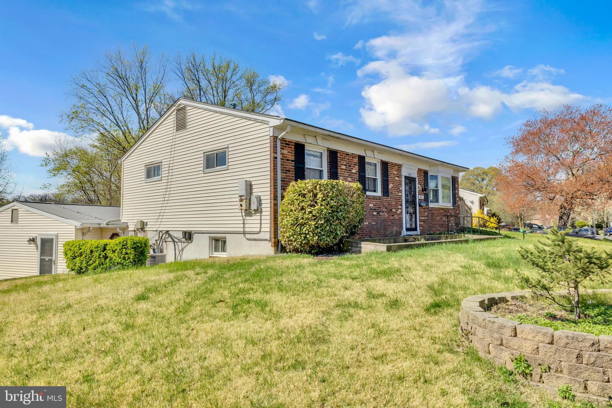 9807 Locust Avenue Lanham, MD 20706 - Photo 6 of 59 a front view of a house with garden