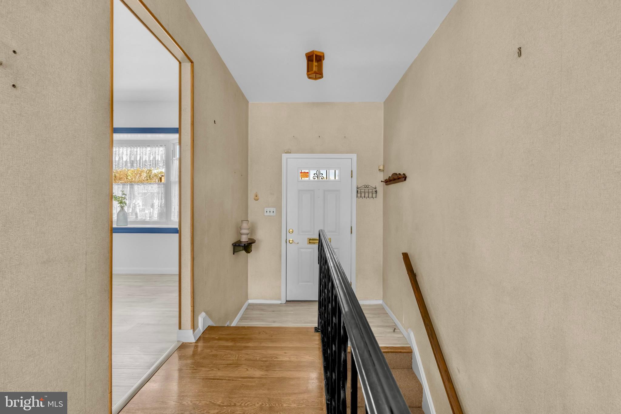 9807 Locust Avenue Lanham, MD 20706 - Photo 9 of 59 a view of a hallway with windows and stairs