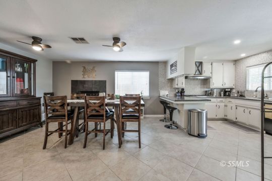 1267 North Erwin Street Ridgecrest, CA 93555 - Photo 12 of 35 a open dining room with kitchen island granite countertop furniture and a fireplace