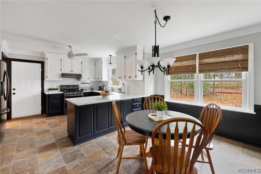 5716 Sandstone Ridge Road Midlothian, VA 23112 - Photo 11 of 36 a kitchen with kitchen island a dining table chairs and a wooden floor