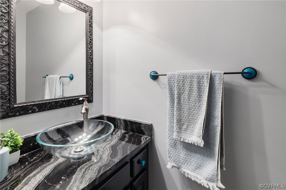 5716 Sandstone Ridge Road Midlothian, VA 23112 - Photo 18 of 36 a bathroom with a granite countertop sink and a mirror
