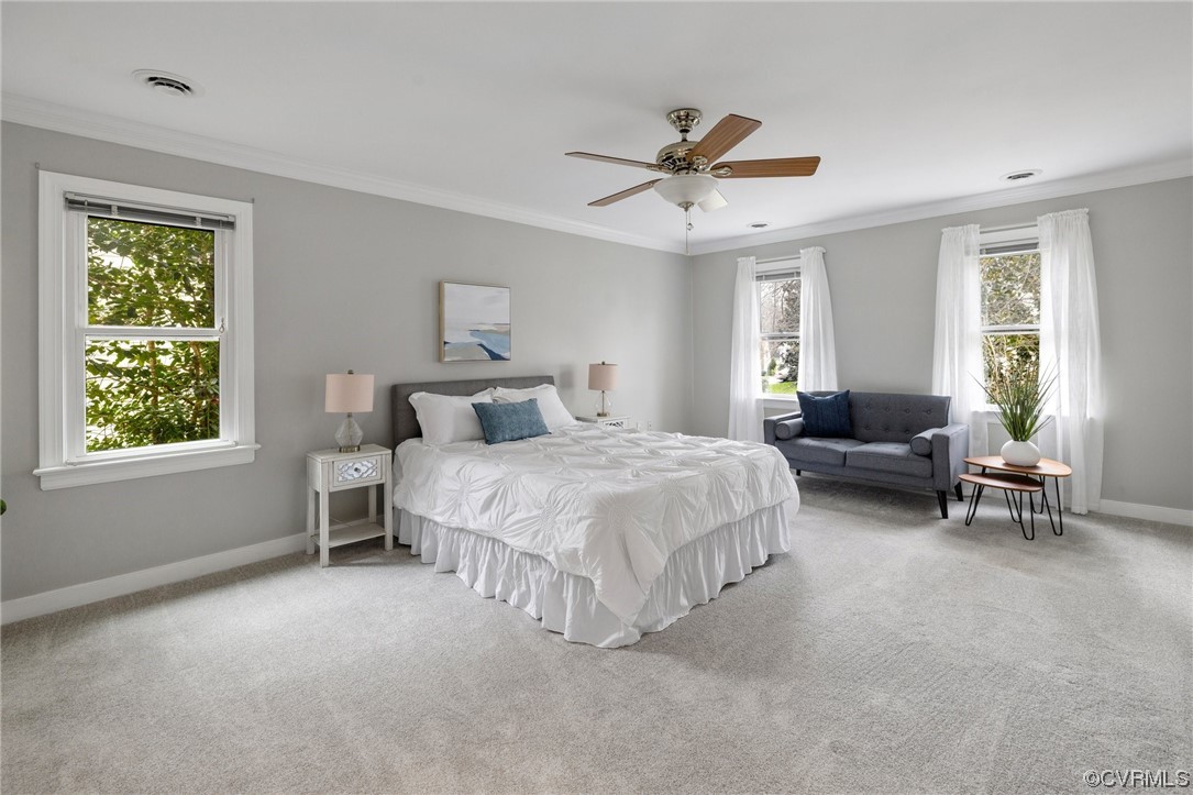 5716 Sandstone Ridge Road Midlothian, VA 23112 - Photo 21 of 36 a spacious bedroom with a bed a couch and a window