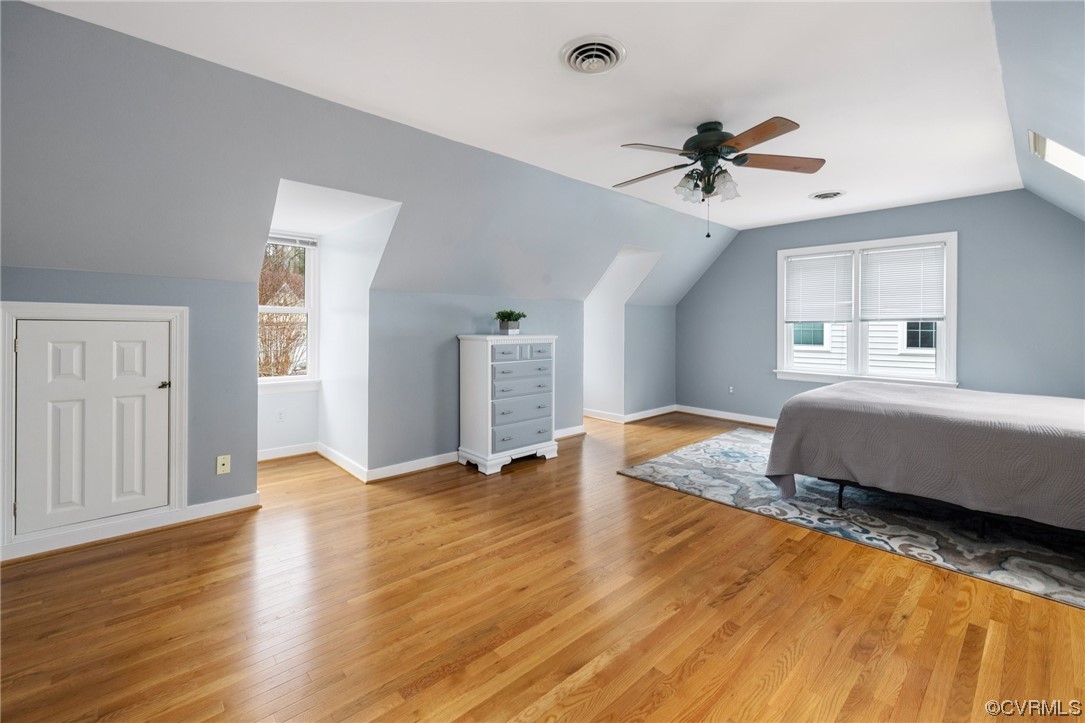 5716 Sandstone Ridge Road Midlothian, VA 23112 - Photo 26 of 36 a spacious bedroom with a bed and wooden floor