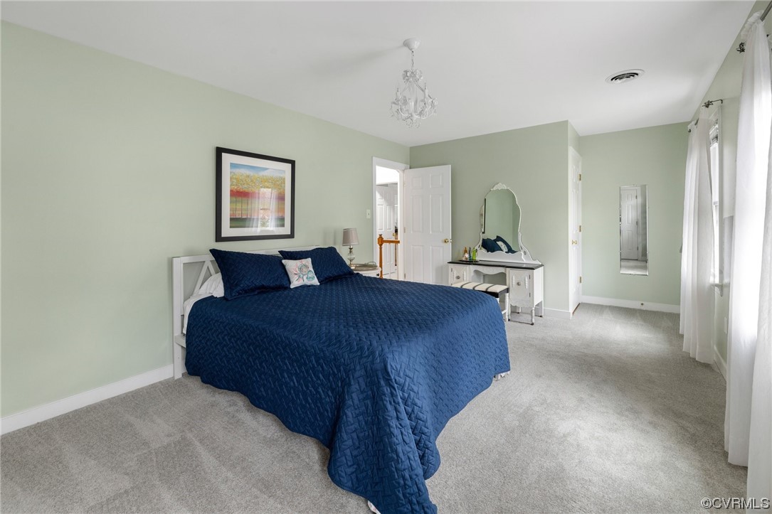 5716 Sandstone Ridge Road Midlothian, VA 23112 - Photo 28 of 36 a bedroom with a bed and a chandelier