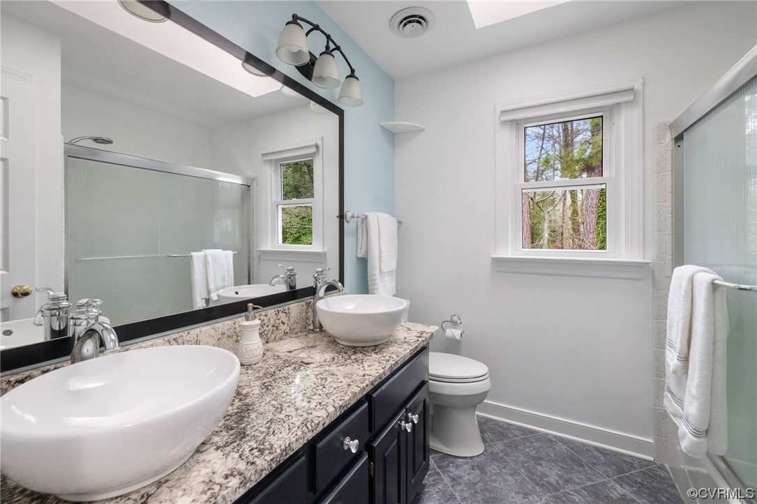 5716 Sandstone Ridge Road Midlothian, VA 23112 - Photo 29 of 36 a bathroom with a granite countertop sink a toilet and a mirror