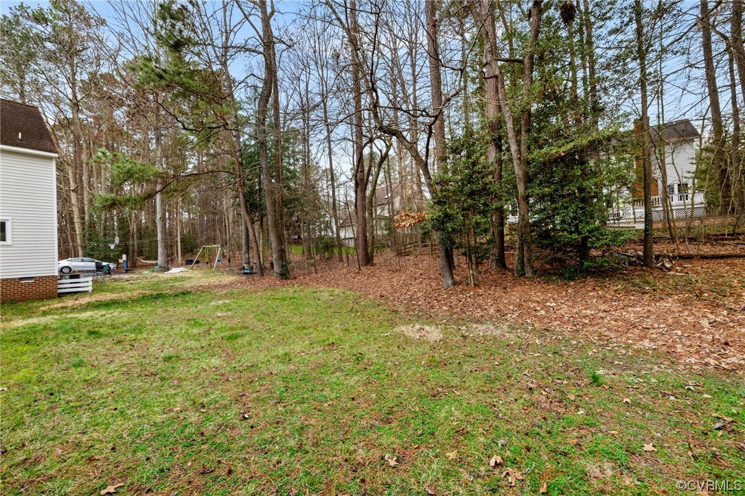 5716 Sandstone Ridge Road Midlothian, VA 23112 - Photo 35 of 36 a backyard of a house with lots of green space and fountain