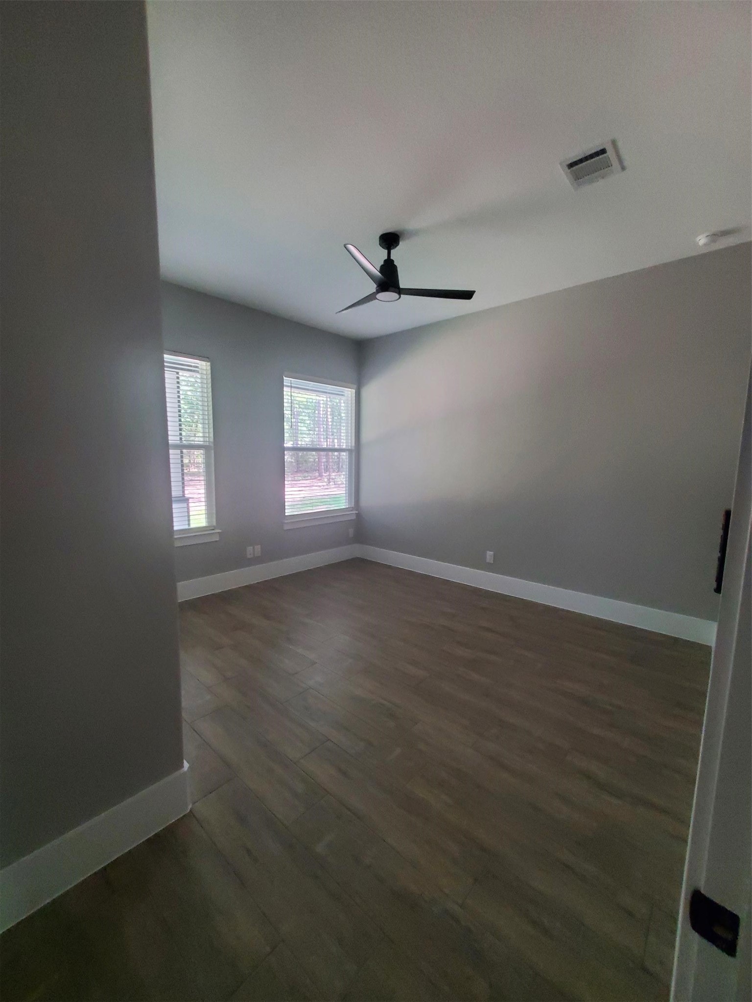 24647 Oak Creek Road Hockley, TX 77447 - Photo 12 of 47 an empty room with wooden floor and windows