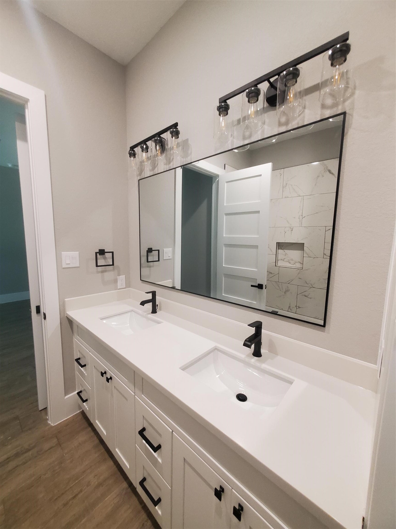 24647 Oak Creek Road Hockley, TX 77447 - Photo 13 of 47 a bathroom with a double vanity sink and mirror