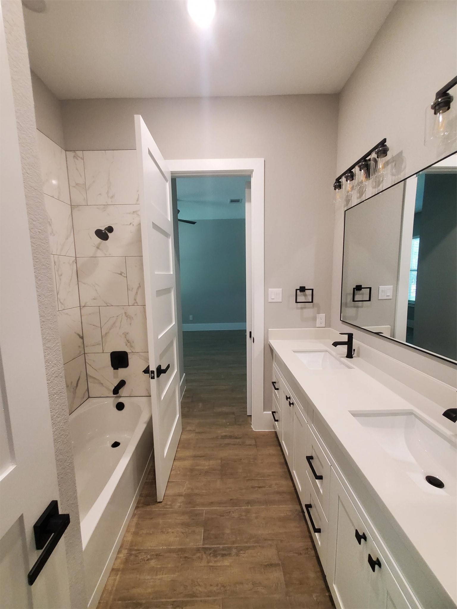 24647 Oak Creek Road Hockley, TX 77447 - Photo 14 of 47 a spacious bathroom with a double vanity sink a large mirror and shower