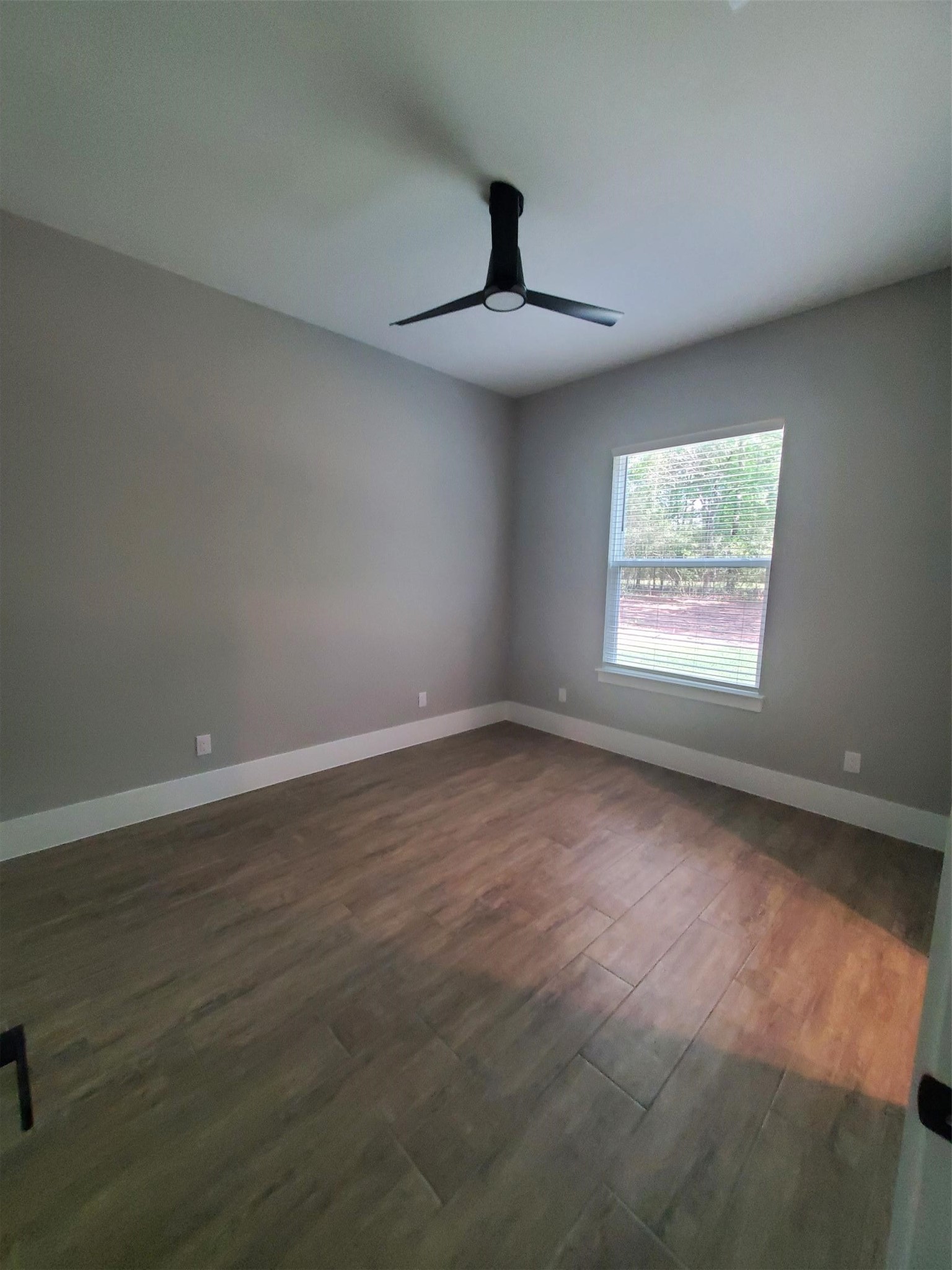 24647 Oak Creek Road Hockley, TX 77447 - Photo 16 of 47 a view of an empty room with wooden floor and a window