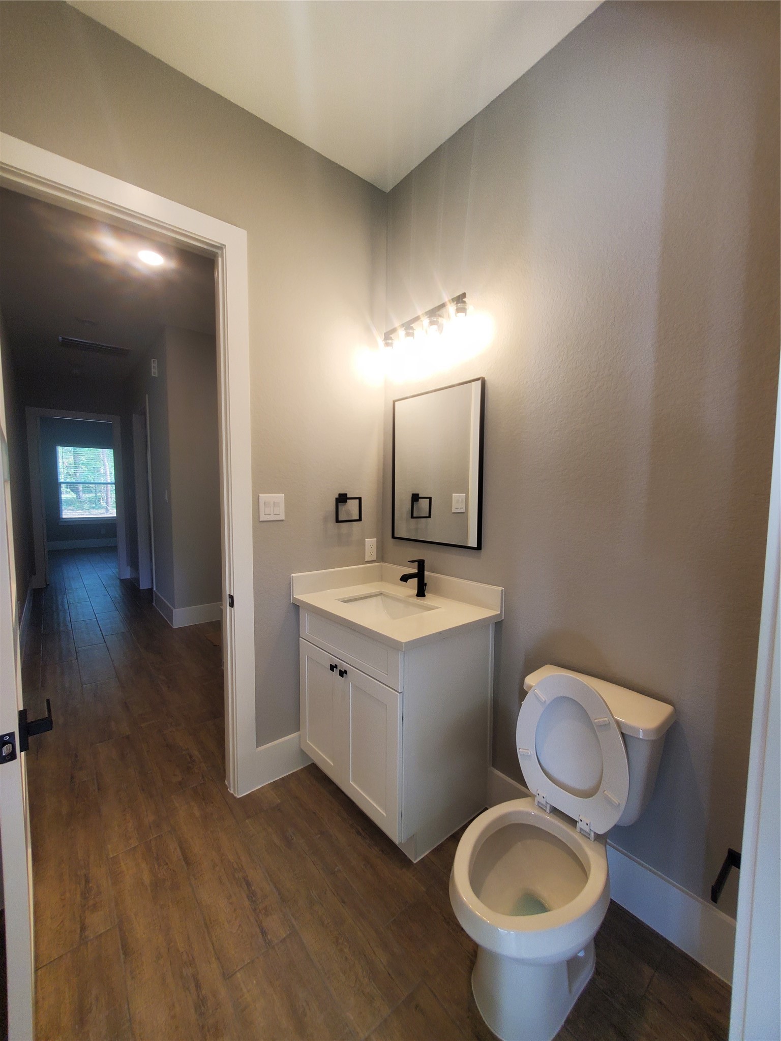 24647 Oak Creek Road Hockley, TX 77447 - Photo 22 of 47 a spacious bathroom with a toilet sink and mirror