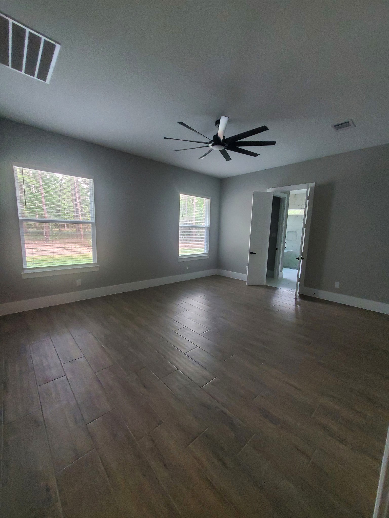 24647 Oak Creek Road Hockley, TX 77447 - Photo 25 of 47 an empty room with wooden floor and windows