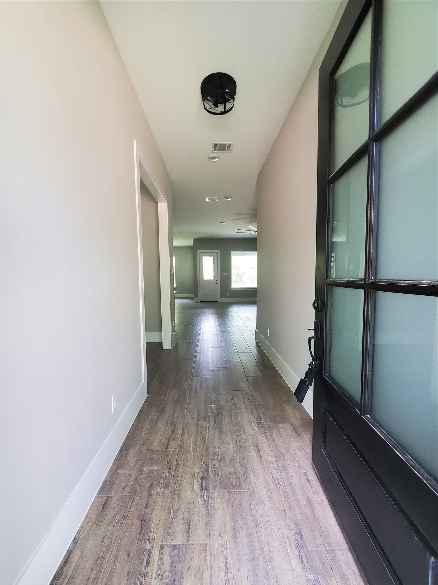 24647 Oak Creek Road Hockley, TX 77447 - Photo 5 of 47 wooden floor in an empty room with a window