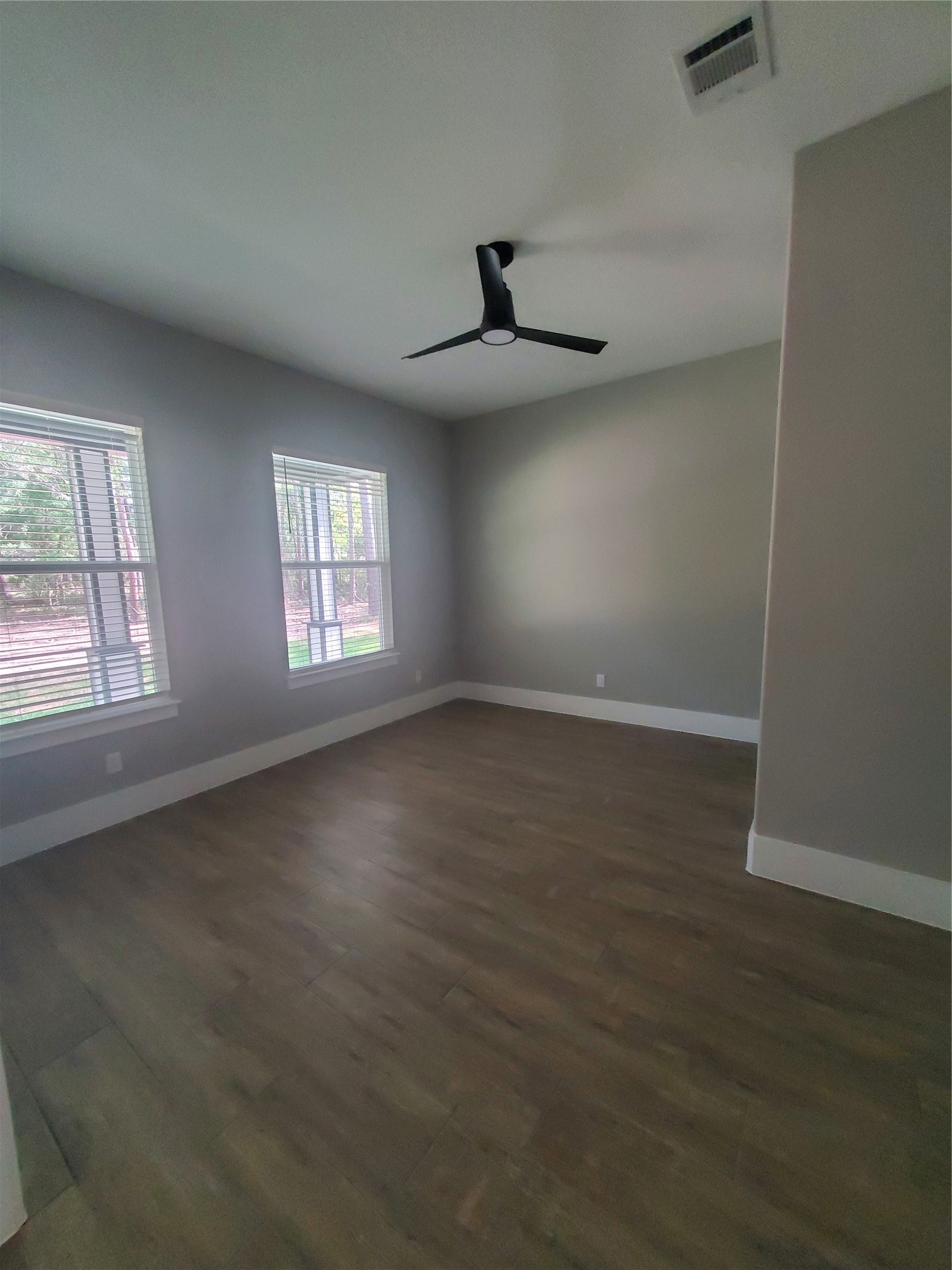 24647 Oak Creek Road Hockley, TX 77447 - Photo 6 of 47 an empty room with wooden floor fan and windows