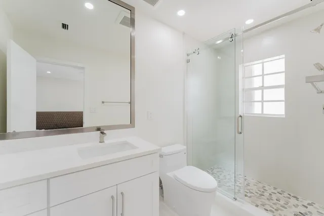 a bathroom with a sink toilet and shower