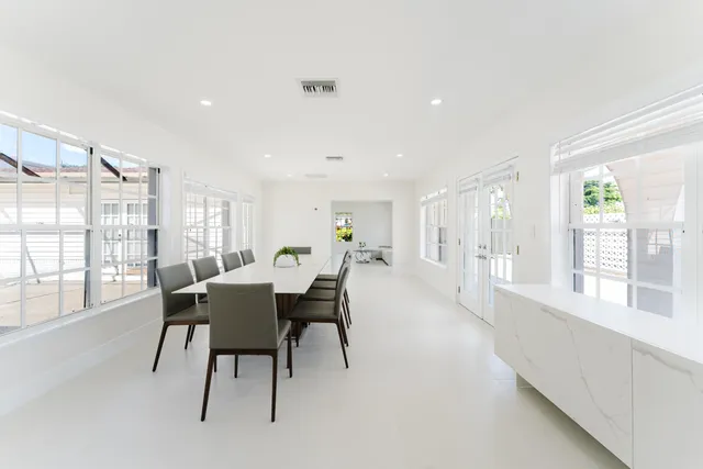 a view of a dining room with furniture a chandelier and wooden floor
