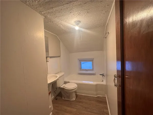 a bathroom with a toilet a sink and shower