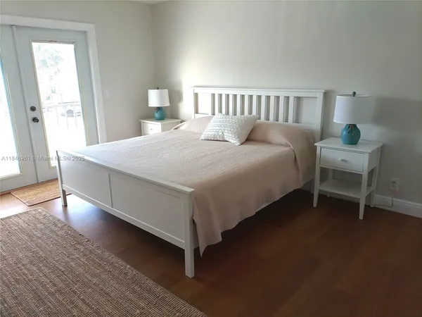 a bed sitting in a bedroom next to a window